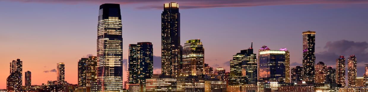 A panoramic view of Arizona's city skyline at dusk showcases modern skyscrapers illuminated against a colorful evening sky, blending hues of orange, pink, and purple. This vibrant setting mirrors the innovative spirit of Online Master's in Education programs designed for future educators.